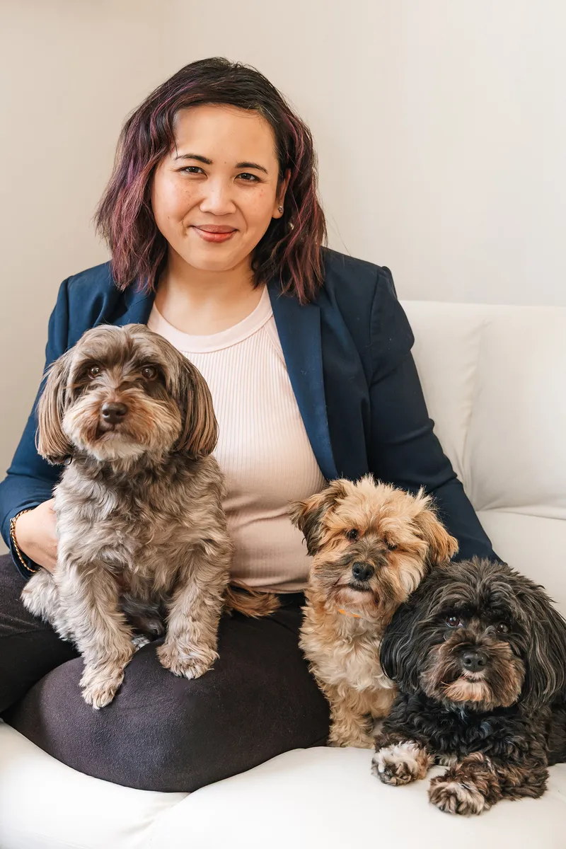 Pet photography business coach Ina J sitting with her two dogs, both looking at the camera